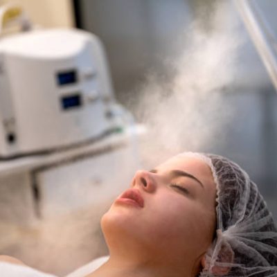 Beauty treatment of face with ozone facial steamer in beauty salon.